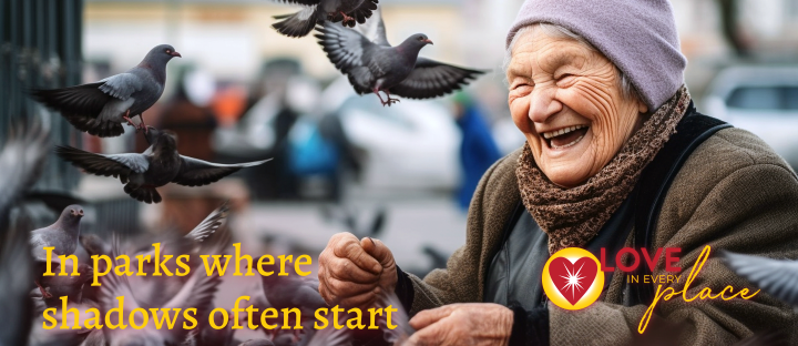 A joyful elderly woman laughing heartily as she feeds a flock of pigeons in a bustling park, with the text 'In parks where shadows often start,' accompanied by the Love in Every Face logo.